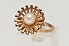 A 9CT GOLD CULTURED PEARL RING, an abstract floral design set with a single cultured pearl,