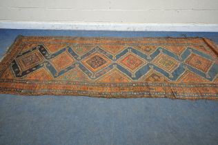 A HAND WOVEN WOOL CARPET RUNNER, with a six medallions, within a blue field and multi strap
