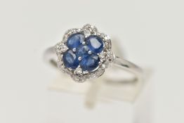 A DIAMOND AND SAPPHIRE DRESS RING, a round cut and four oval cut sapphires prong set as a quatrefoil