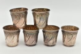 A SET OF SIX WHITE METAL SHOT GLASSES, each with an embossed leaf design with gilt interior, each