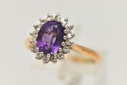 AN AMETHYST AND DIAMOND DRESS RING, an oval cut amethyst prong set in white gold, set with a