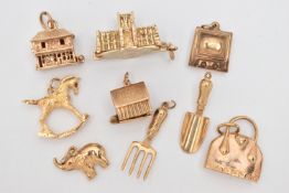NINE CHARMS, to include seven 9ct gold charms in forms such as a handbag, shovel, television,