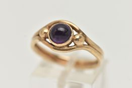 A 9CT GOLD AMETHYST RING, designed as a central amethyst cabochon in a collet setting to the outer