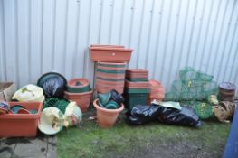 A LARGE COLLECTION OF PLASTIC PLANTERS AND HANGING BASKETS including wire globes, baskets, and