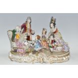 A DRESDEN FIGURE GROUP, an early 20th century German porcelain figure group depicting a joyful