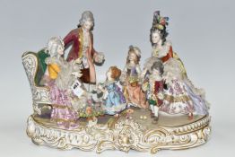 A DRESDEN FIGURE GROUP, an early 20th century German porcelain figure group depicting a joyful