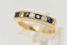 AN 18CT GOLD DIAMOND AND SAPPHIRE BAND RING, three round brilliant cut diamonds and four round cut