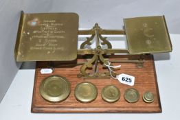 A SET OF BRASS POSTAL SCALES, mounted on wooden plinth, no makers marks, complete with six brass