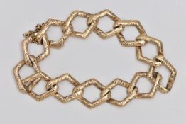 AN EARLY 20TH CENTURY YELLOW METAL BRACELET, a fancy link chain bracelet with etched detail,