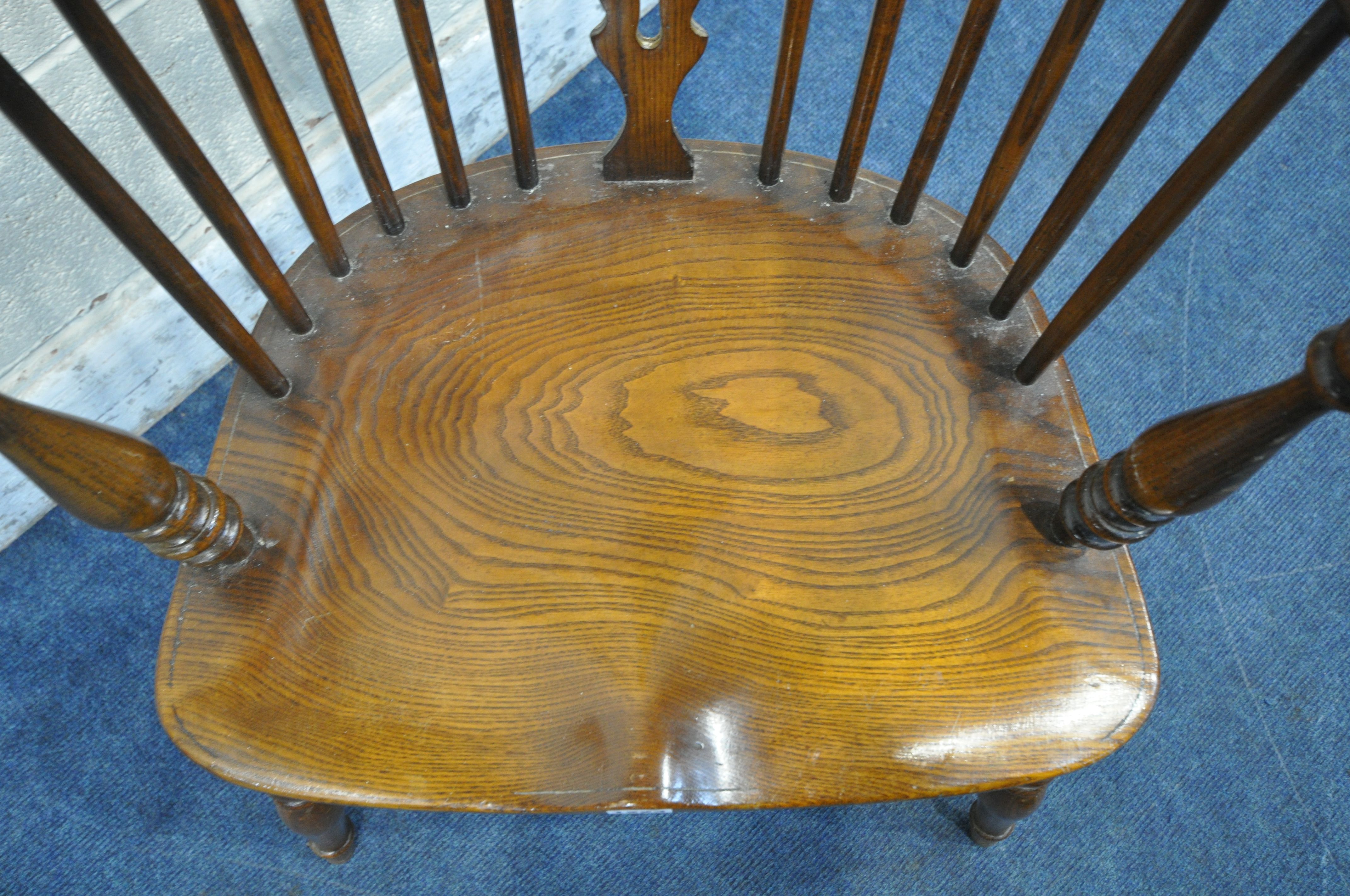 A REPRODUCTION ELM SEATED WHEEL BACK WINDSOR ARMCHAIR, with turned supports and legs, united by a - Image 3 of 3