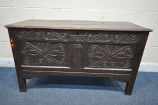 A GEORGIAN OAK COFFER, the a hinged lid enclosing a candle box, scrolled carving to front panels, on