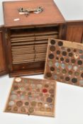 A WOODEN COIN CABINET COMPRISING OF 19 DRAWERS OF COINAGE FROM 16th-20th CENTURY, to include Crown