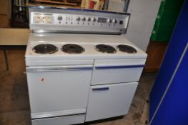 A VINTAGE G.E.C. ELECTRIC RANGE COOKER with four top rings, two oven, one grill and drawer width