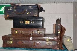 A COLLECTION OF SIX PIECES OF EARLY TO MID CENTURY TRAVELLING LUGGAGE, comprising a brown leather