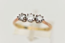 A THREE STONE DIAMOND RING, a centrally set old cut diamond, prong set in white metal with two round