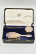 A CASED EARLY 20TH CENTURY TRAVEL SET, comprising of a polished silver hair brush, a silver lined