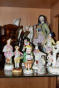 A COLLECTION OF NINETEENTH CENTURY STAFFORDSHIRE AND SIMILAR FIGURES, to include a treacle glazed