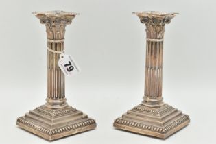 A PAIR OF LATE VICTORIAN SILVER CANDLE STICKS, Corinthian columns scroll leaf detail, on square