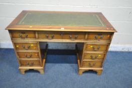 A 20TH CENTURY YEW WOOD TWIN PEDESTAL DESK, with green tooled leather writing surface, fitted with