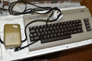 COMMODORE 64 COMPUTER, doesn't include any video cables, however it does power on, together with