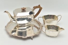 A GEORGE VI THREE PIECE TEA SET, comprised of a tea pot a sugar bowl and milk jug, art deco style