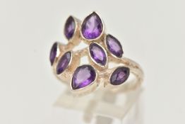 AN AMETHYST RING, designed as pear and marquise cut amethysts in collet settings to the branch style