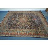 A 20TH CENTURY WOOLEN RUG, with repeating foliate design, central medallion, within a blue field,
