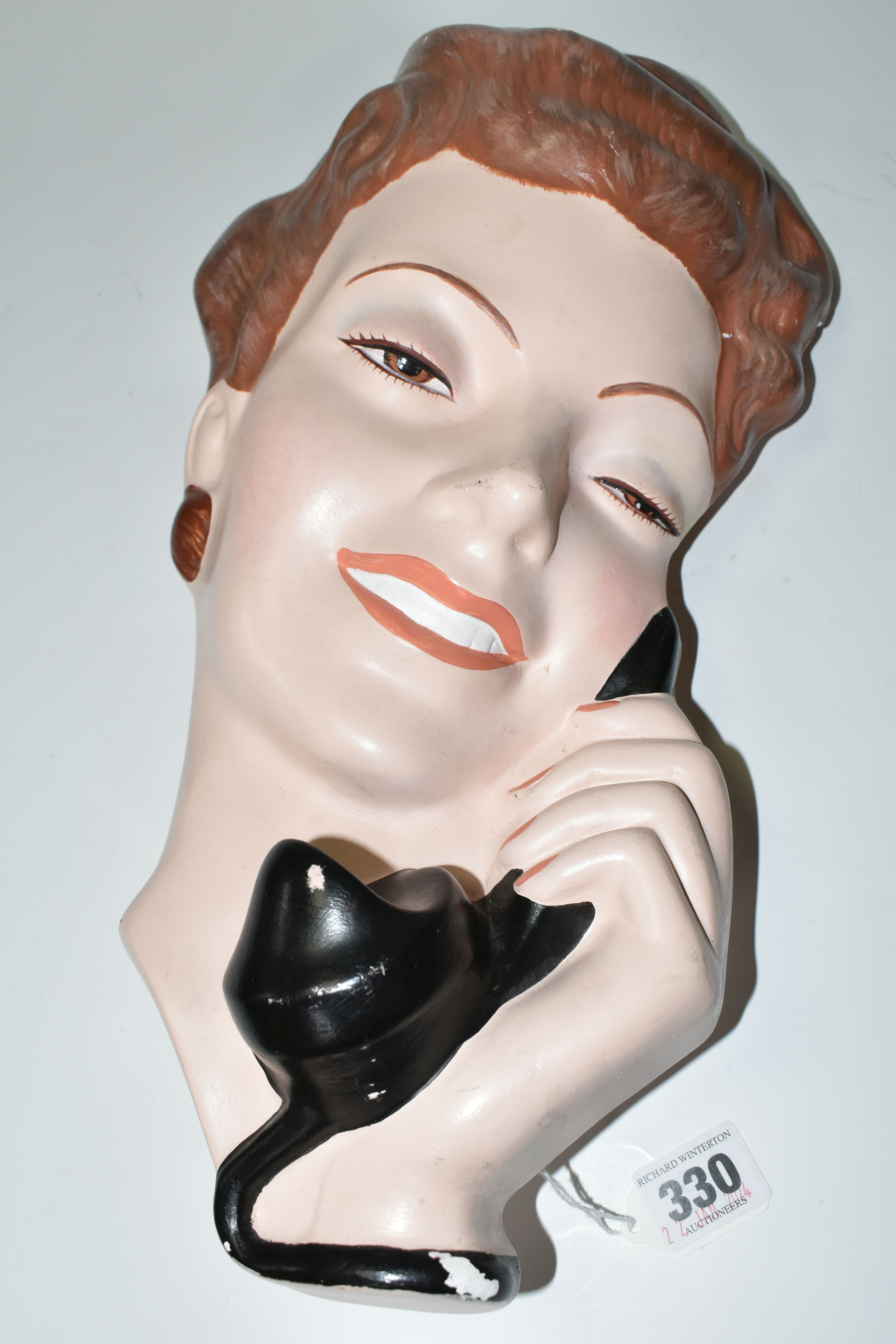 A LARGE PLASTER WALL PLAQUE OF A 1940S STYLE YOUNG WOMAN WITH A TELEPHONE, height 37.5cm x width