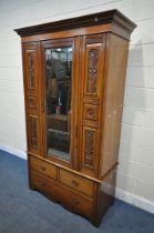 AN EARLY 20TH CENTURY WALNUT SINGLE MIRROR DOOR WARDROBE, with foliate and pokerwork panels, above