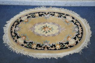A YELLOW GROUND CHINESE WOOLEN RUG, with floral medallion and border, 163cm x 103cm (condition