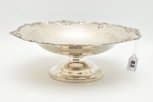 A GEORGE V SILVER FRUIT BOWL, polished bowl decorated with an open work wavy rim, raised on a