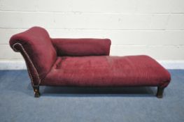A 20TH CENTURY CHAISE LOUNGE, with burgundy studded upholstery, length 161cm x depth 65cm x height
