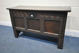 A 16TH/17TH CENTURY OAK PANELLED COFFER, with geometric pattern and repeating symbols, width 109cm x