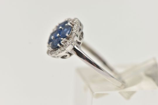 A DIAMOND AND SAPPHIRE DRESS RING, a round cut and four oval cut sapphires prong set as a quatrefoil - Image 2 of 4