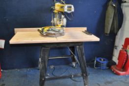 A DeWALT DW721 RADIAL ARM SAW ON STAND with blade guard removed due to oversized blade being