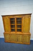 A 20TH CENTURY WALNUT BOOKCASE, the top section with two cupboard doors, flanking double glazed