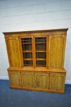 A 20TH CENTURY WALNUT BOOKCASE, the top section with two cupboard doors, flanking double glazed