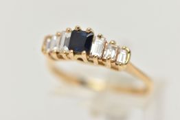 A DIAMOND AND SAPPHIRE DRESS RING, a principally set cushion cut sapphire, flanked with six baguette