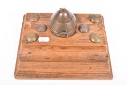 A WWI OR WWII TRENCH ART INKWELL AND WOODEN DESK TIDY, the inkwell has been converted from an
