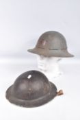 TWO WORLD WAR TWO ERA STEEL HELMETS, these include a black Brodie helmet with liner and chinstrap
