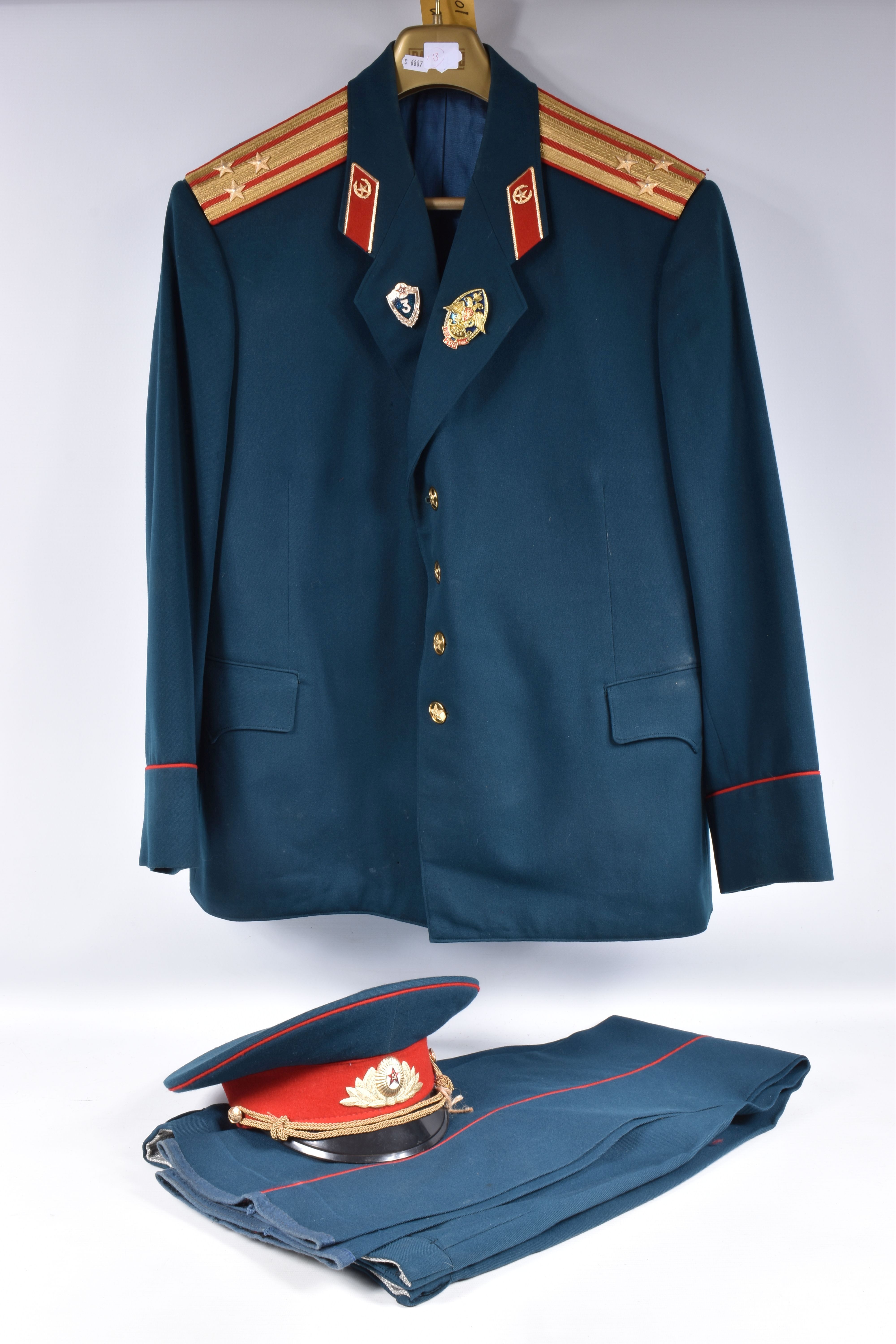A RUSSIAN ARMY COLONELS UNIFORM, comprising of a tunic , trousers and a hat, the uniform is green