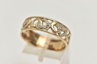 A 9CT GOLD BAND RING, open work wide band, detailed with hearts set with single cut diamond accents,