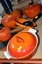 A SMALL GROUP OF ORANGE CAST IRON COOKWARES ETC, comprising a Le Creuset 24cm casserole dish, two