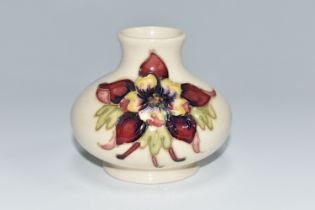 A MOORCROFT POTTERY SQUAT COLUMBINE VASE, tube lined with purple, red and yellow columbine flowers