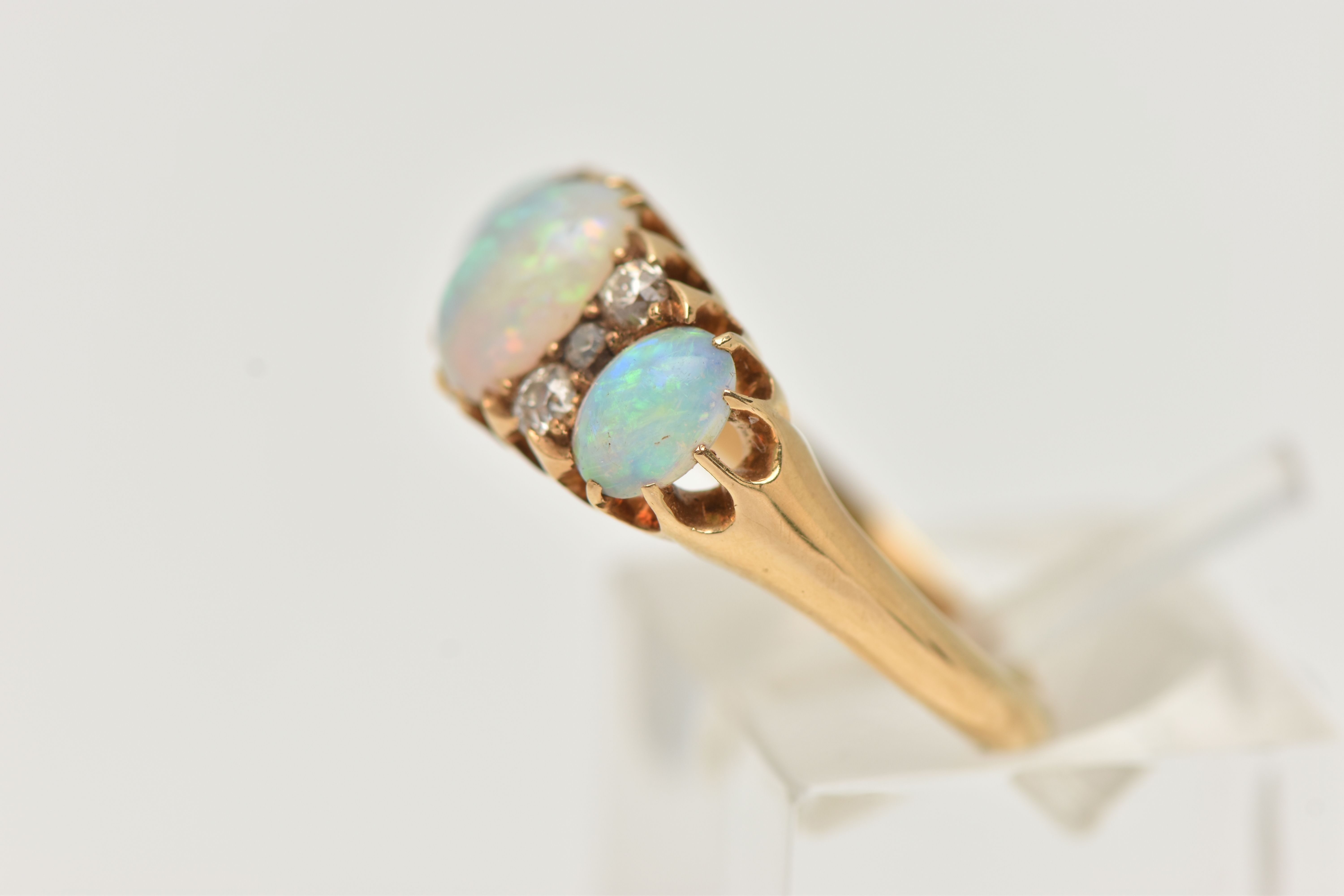AN EARLY 20TH CENTURY OPAL AND DIAMOND RING, three oval cabochon opals prong set in yellow metal, - Image 2 of 4