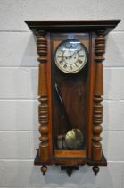 A 19TH CENTURY WALNUT VIENNA REGULATOR WALL CLOCK, the arched glazed door enclosing an enamelled 7