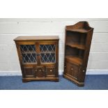 A 20TH CENTURY OAK BOOKCASE, the double lead glazed doors enclosing a single shelf, above two