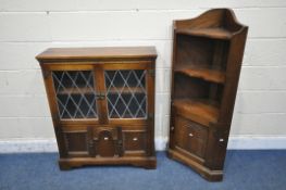 A 20TH CENTURY OAK BOOKCASE, the double lead glazed doors enclosing a single shelf, above two