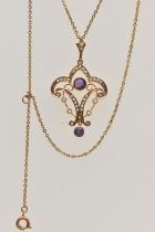 AN EARLY 20TH CENTURY LAVALIER PENDANT, a yellow metal open work pendant with scrolling design,