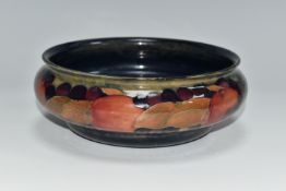 A MOORCROFT POTTERY POMEGRANATE BOWL, decorated with pomegranates on a mottled blue ground,
